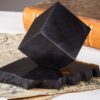 Polished shungite cube on the stand